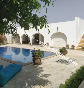 View of the villa from the garden with the swimming pool in the foreground