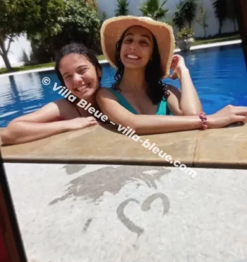 Two girls smiling in the pool
